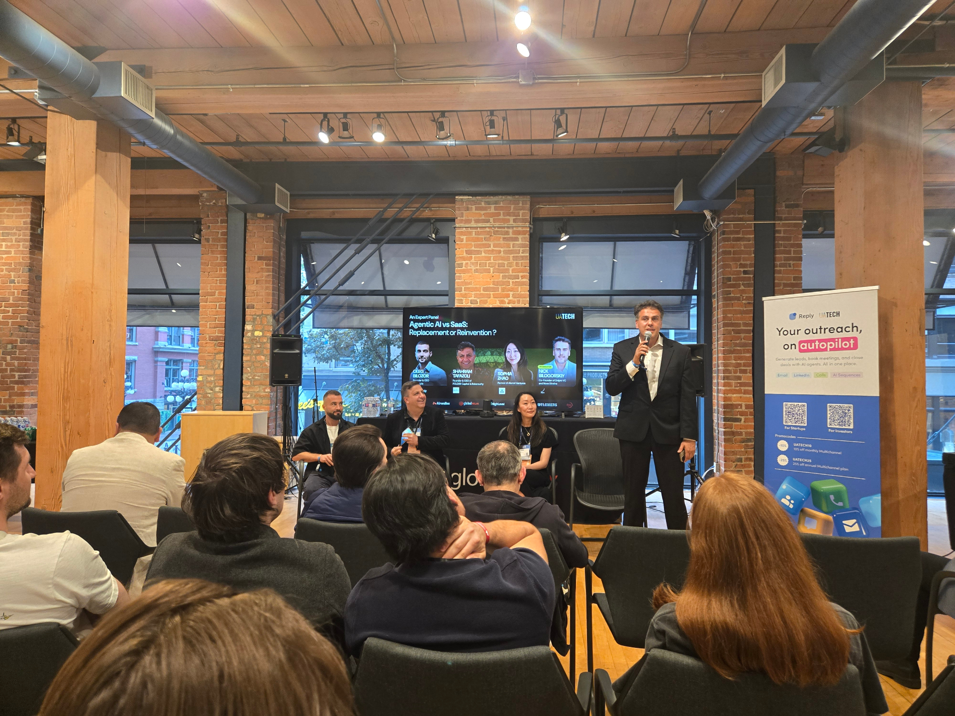 UATECH side-event expert panel on Agentic AI vs SaaS during Websummit Vancouver, moderator introducing panelists on stage